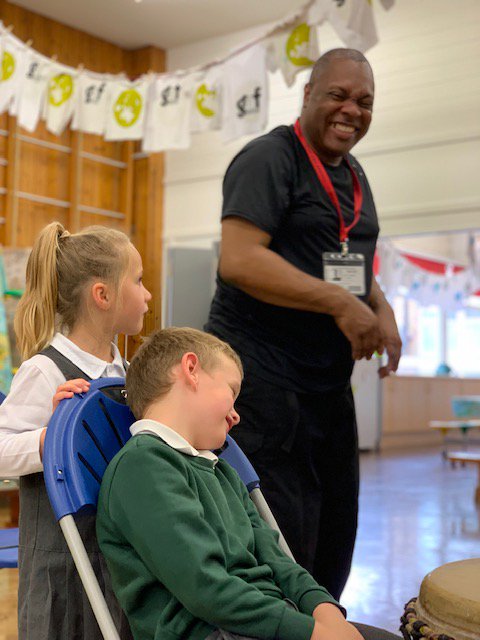 Teacher teaching African dancing to school children