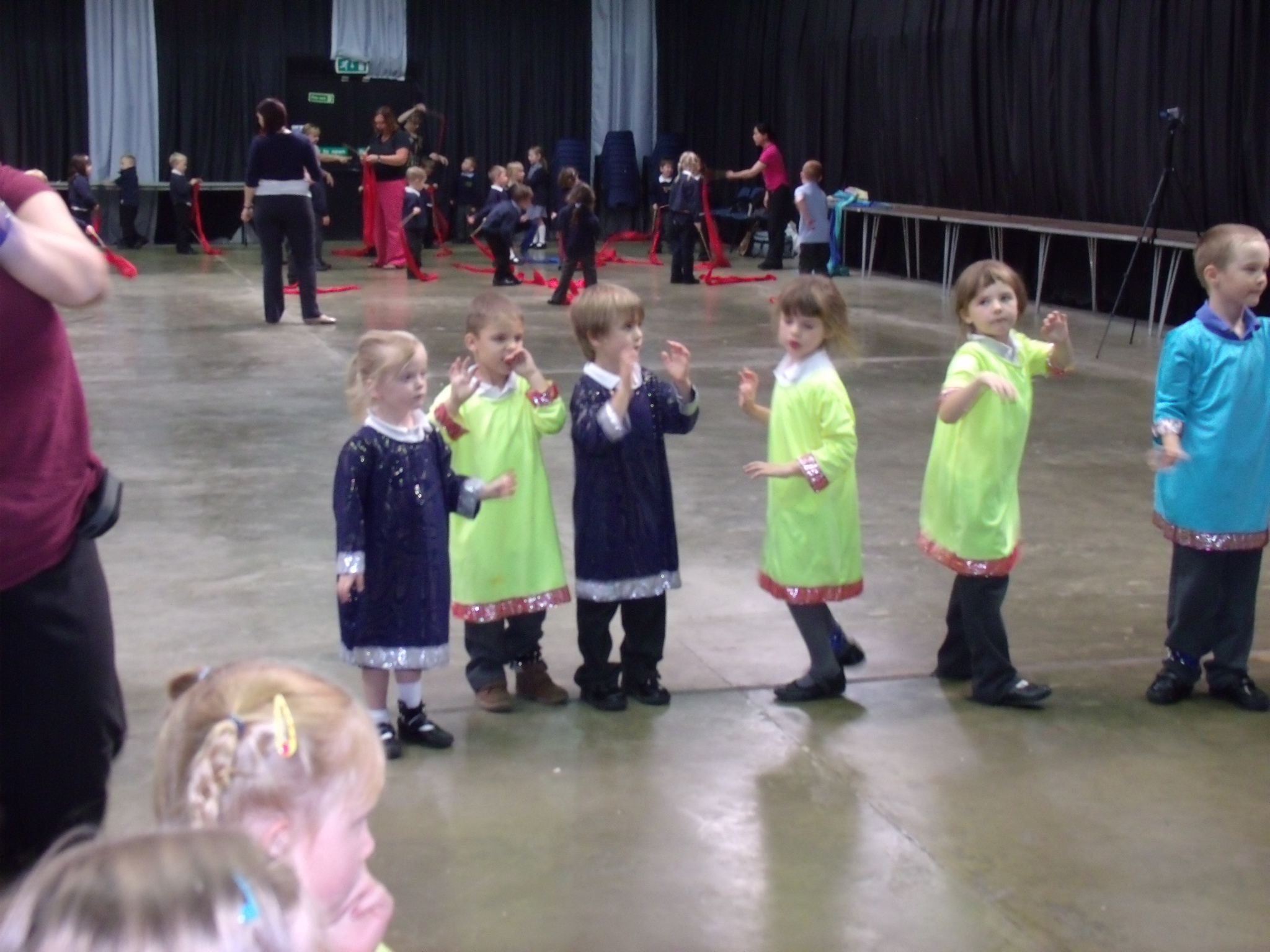 School children dressed in bright Indian clothing learning Indian dance