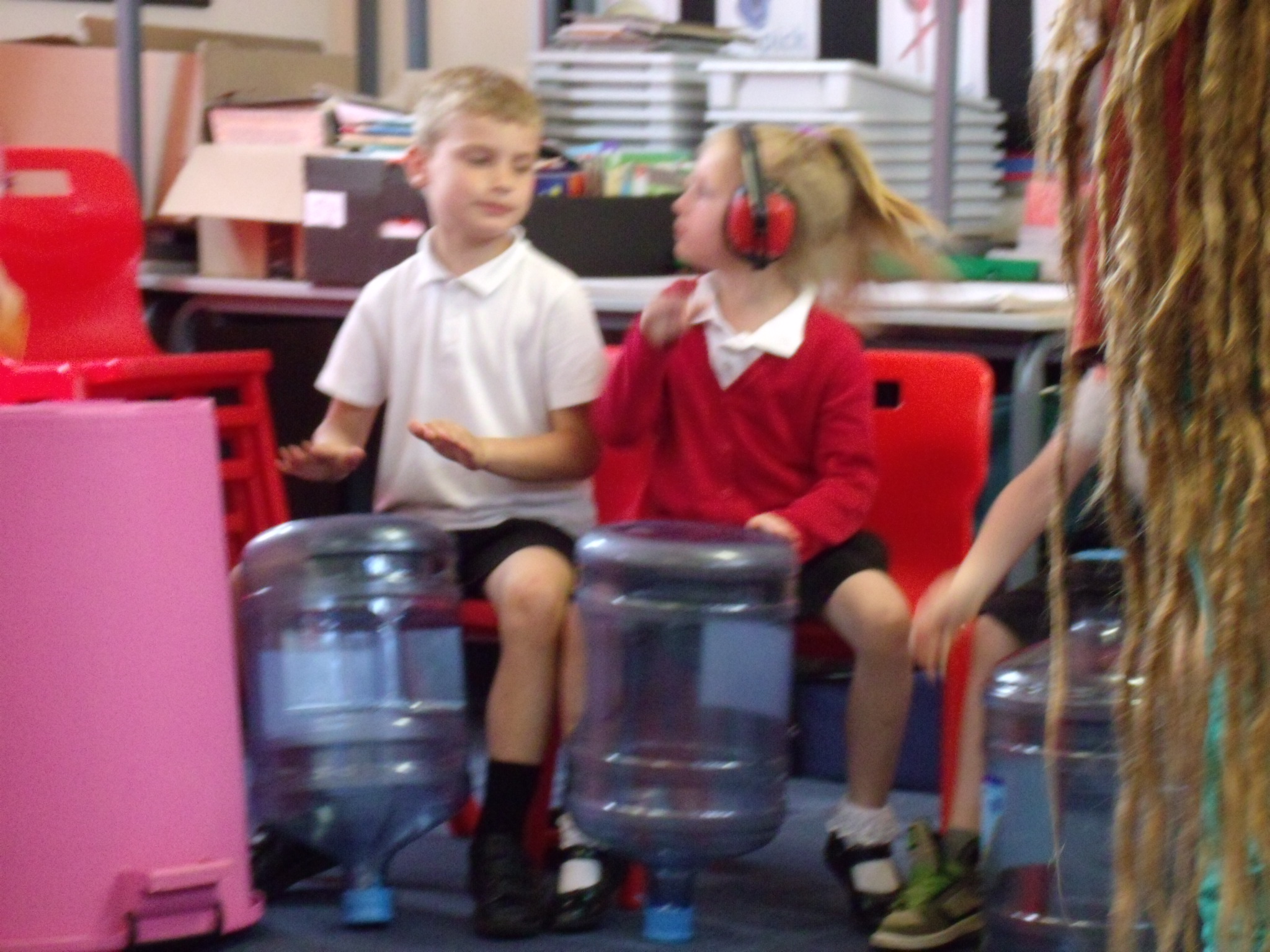 School children playing music on recycled empty bottles