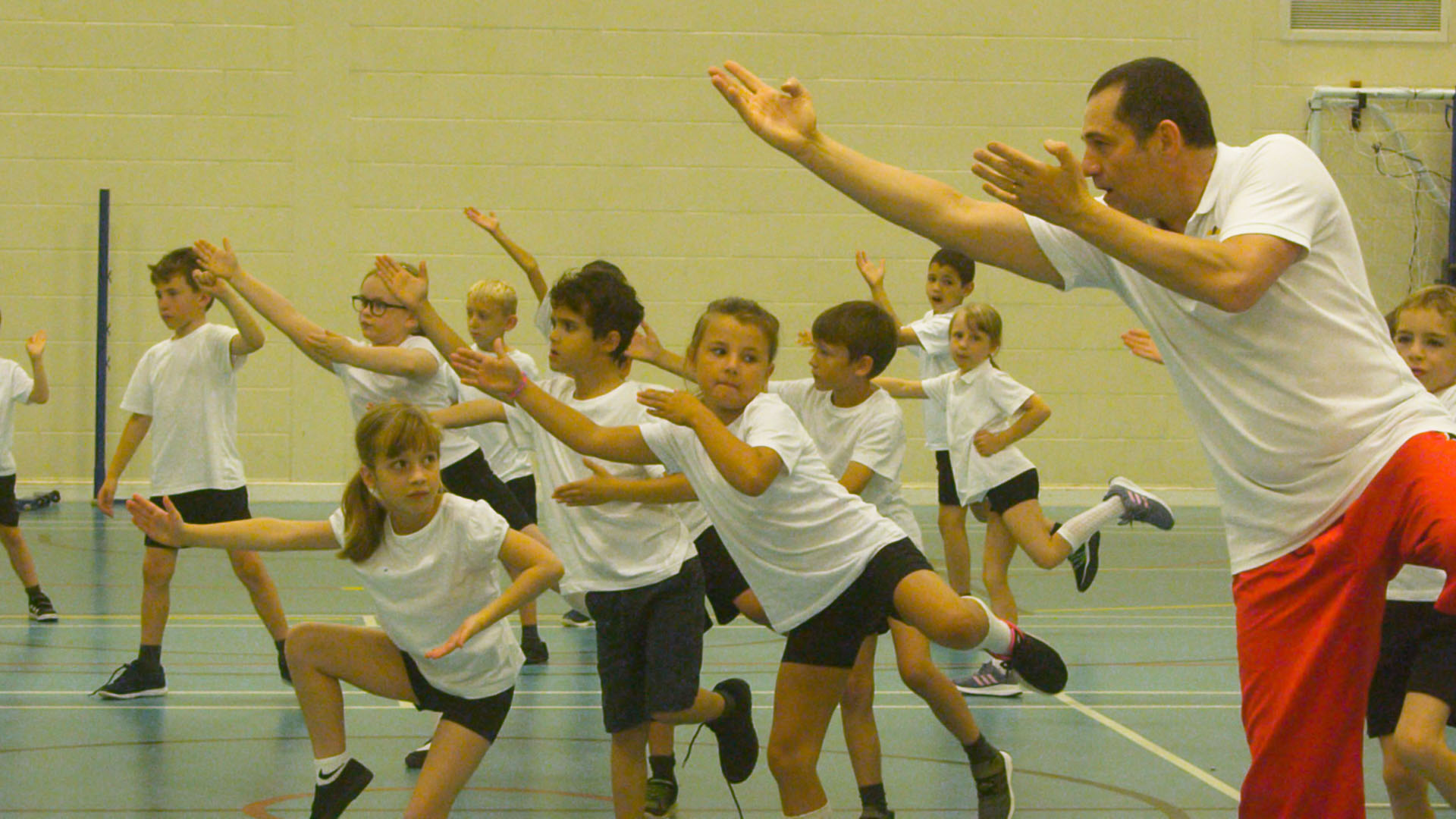 Children and teacher performing martial arts