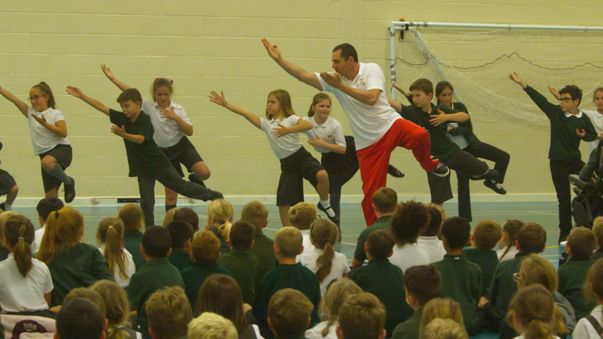 Children and teacher performing martial arts