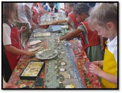 School children creating a mosaic