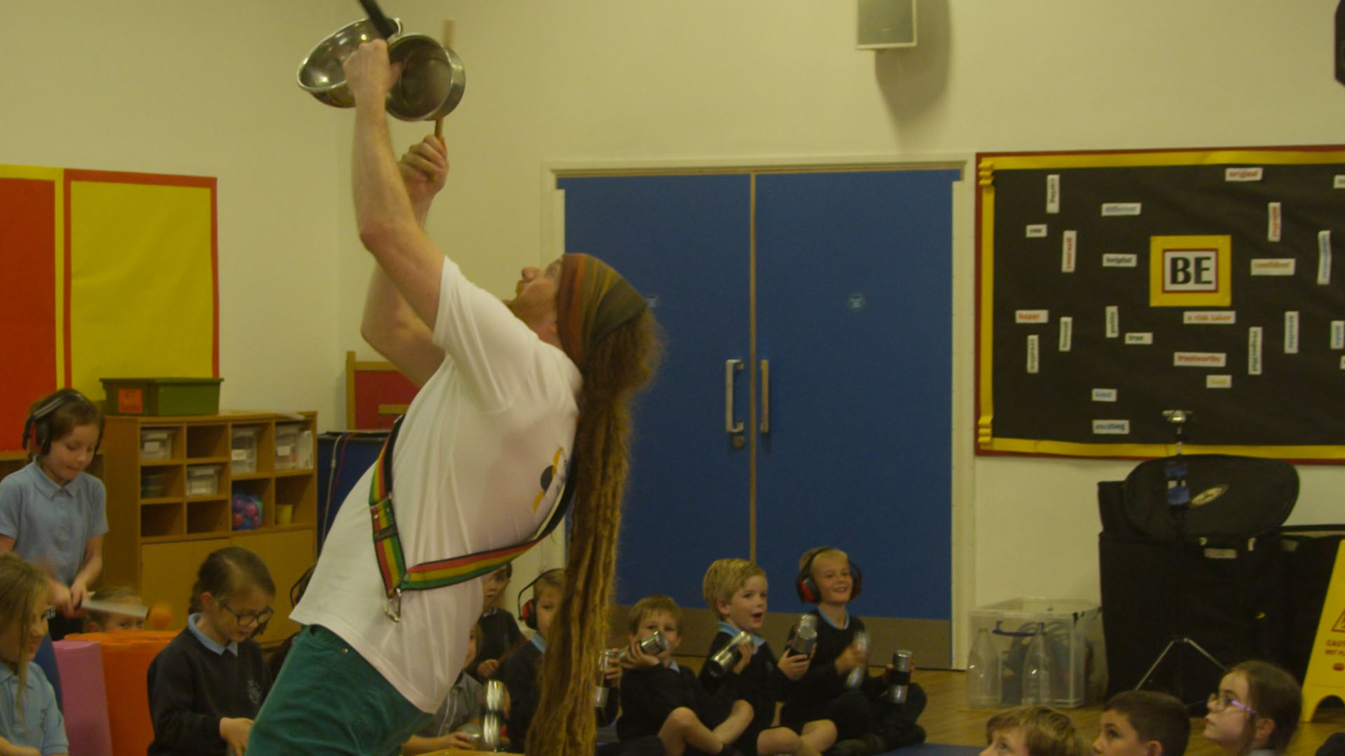 Teacher demonstrating to school children how to play Samba drums