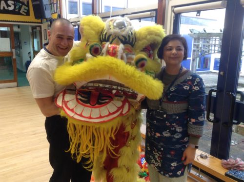 Teachers holding yellow lion dance costume